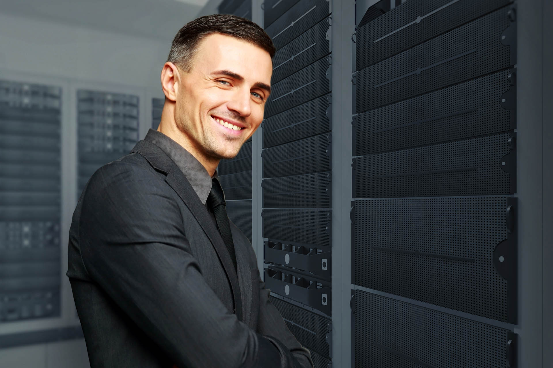 Smiling businessman with arms folded standing on gray background businessman