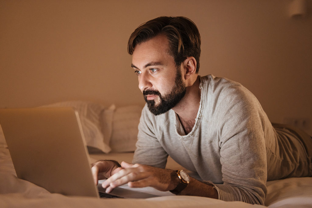 Portrait of a concentrated man using laptop computer